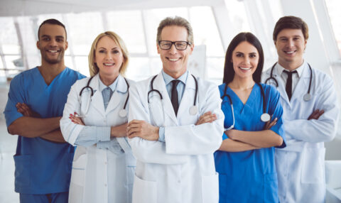 successful,team,of,medical,doctors,are,looking,at,camera,and